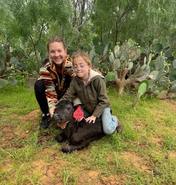 4Crosses family members with a Wagyu calf in the pasture